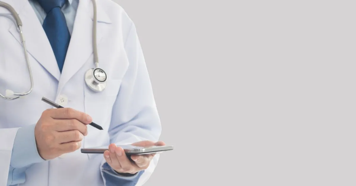 Responsabilidade civil médica. Médico com estetoscópio usando tablet. Quando hospital ou profissional deve indenizar.