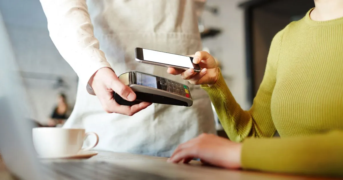 Pessoa realizando pagamento por PIX com o celular, representando pensão alimentícia e PIX em 2025.